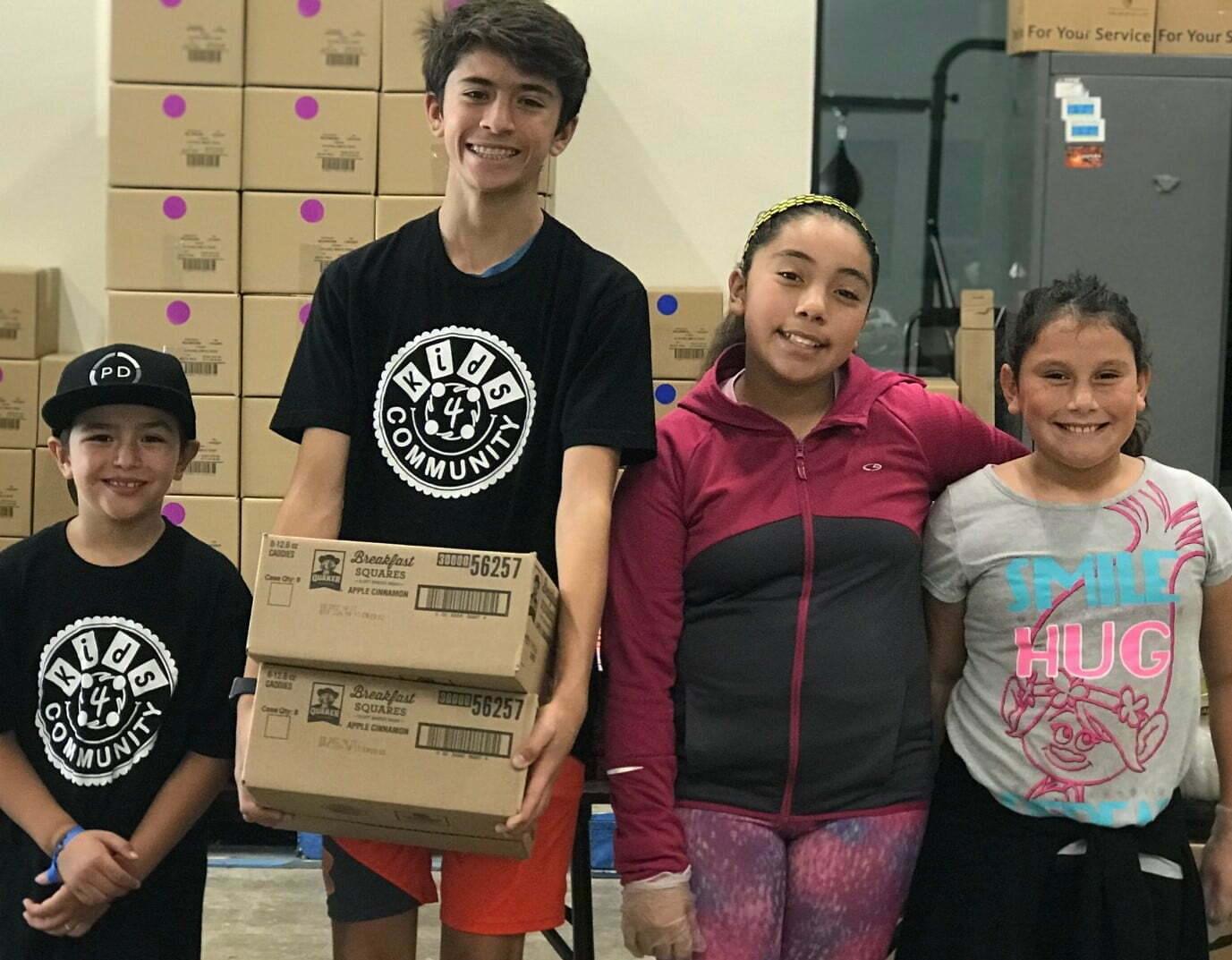 Kenan, second to left, leads a Kids4Community packing hygiene kits for the homeless.