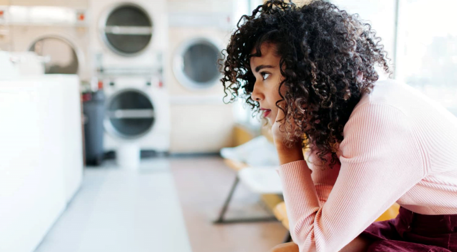Frustrated woman waiting for laundry