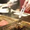 measuring steak temperature on grill 600nw 418872367