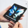 Belgrade, Serbia - December 24, 2021: New Samsung Galaxy Z Fold3 5G mobile cellphone is shown opened unfolded in hands.