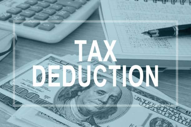 Tax deductions. Office table with financial report.