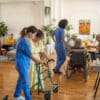 Usual day in crowded nursing home, healthcare workers working with senior people in nursing home