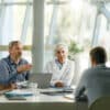 Team of doctors and businessmen communicating while having a meeting at doctor's office in the hospital.