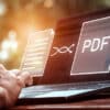 Convert PDF files with online programs. Users convert document files on a platform using an internet connection at desks. concept of technology transforms documents into portable document formats.