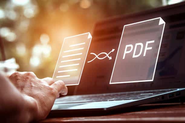 Convert PDF files with online programs. Users convert document files on a platform using an internet connection at desks. concept of technology transforms documents into portable document formats.