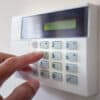 Security alarm keypad with person arming the system concept for crime prevention