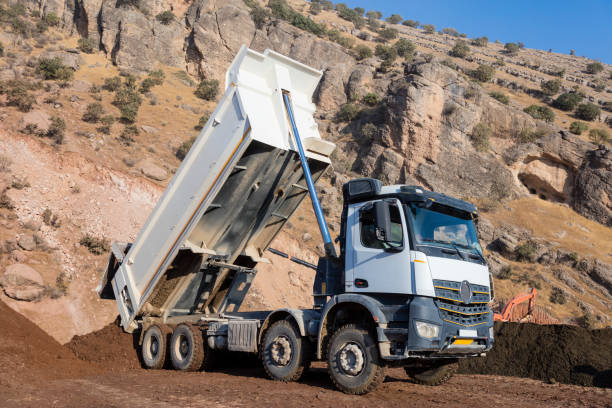 White Dump truck unloading soil