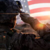 Female Solider Saluting US Flag at Sunrise