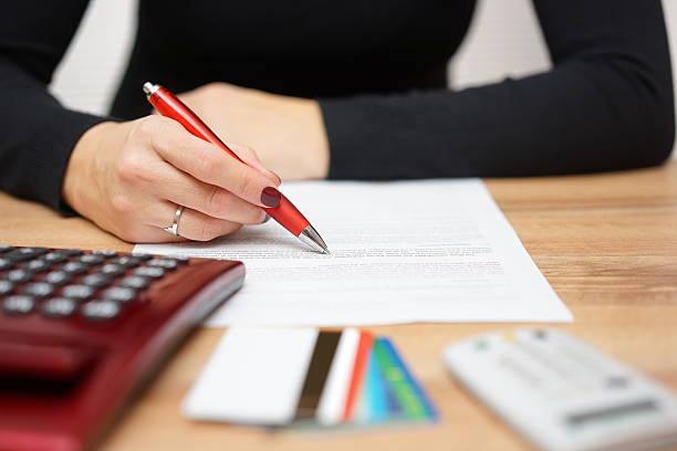 woman is reading bank notice about credit card spending and repayment of debt