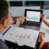 Image of a team of asian business people doing market research and business plans in office