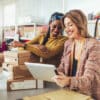 Sales Online. Working women at their store. They accepting new orders online and packing merchandise for customer.